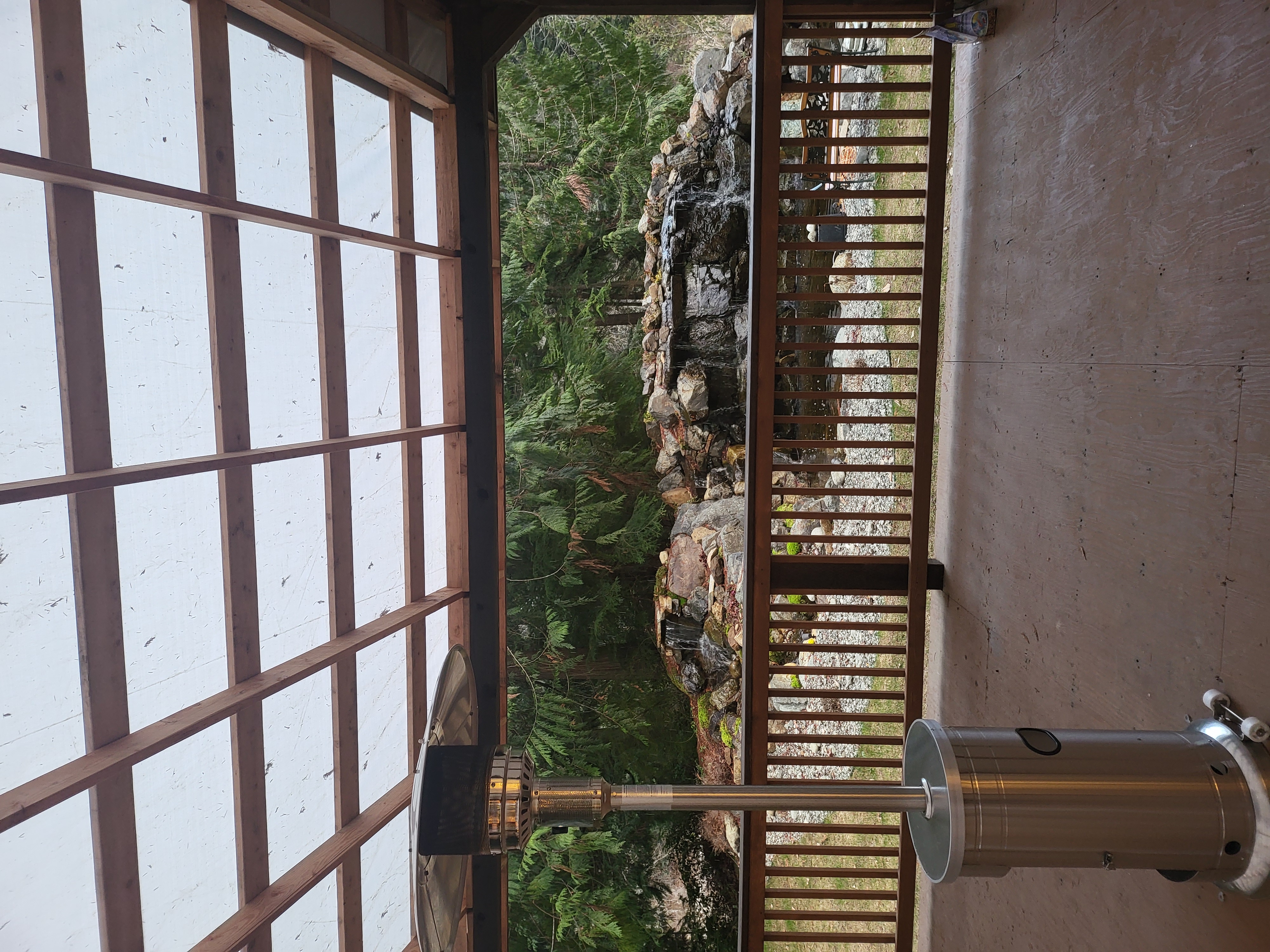 Waterfall beside Covered Patio Area with Heaters