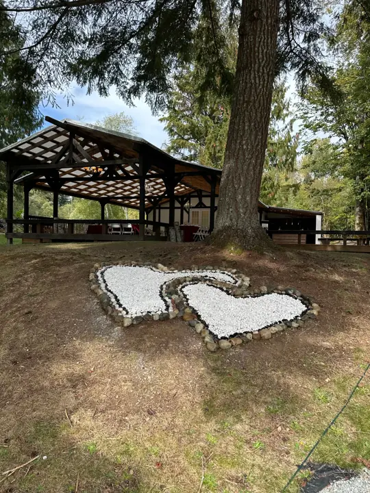 Double white hearts in stone on the lawn, with the covered patio beyond