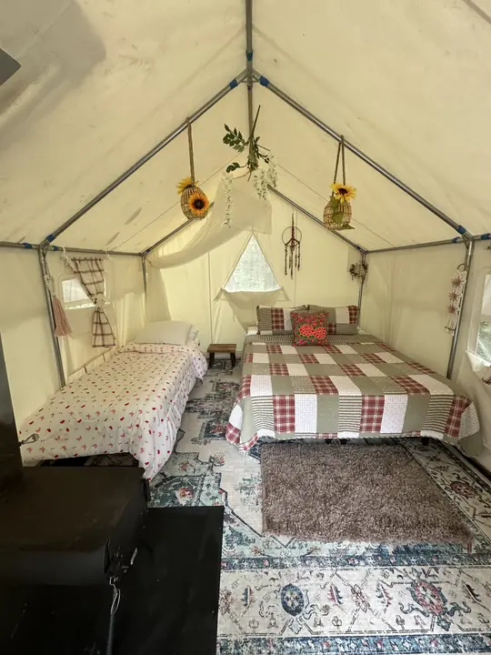 The sunflower tent, set up with a queen bed and a cot