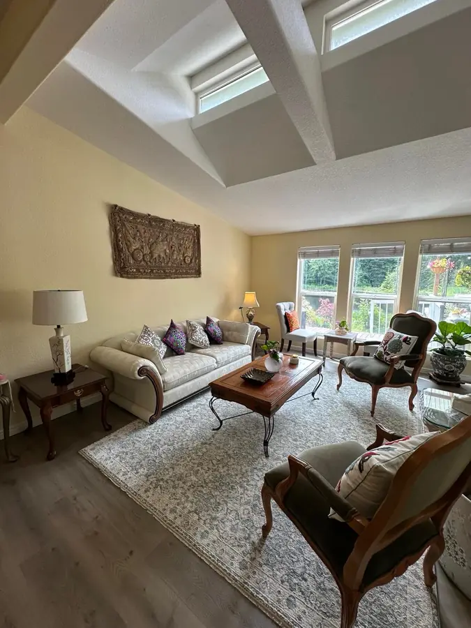 The living room, with French armchairs and windows onto the garden