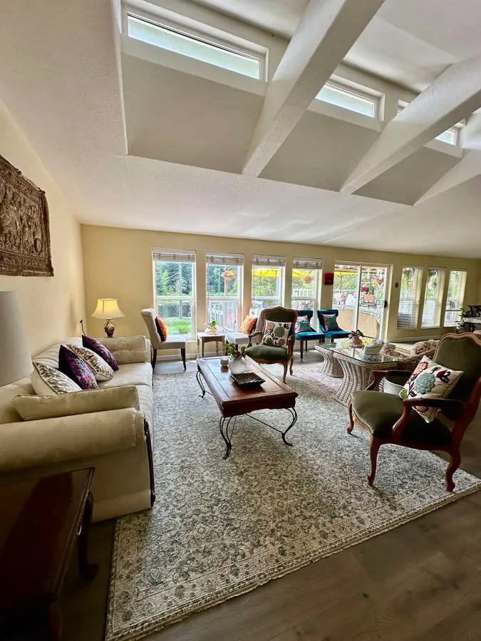 The Lake House living room, with clerestory windows and a wall of glass onto the deck and lake