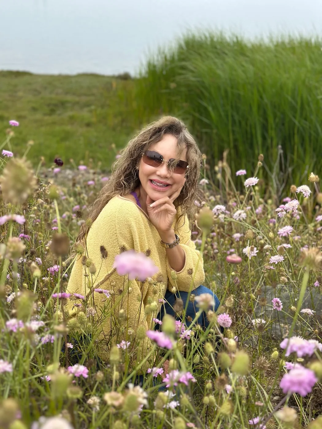Ploenta smiling among pink wildflowers