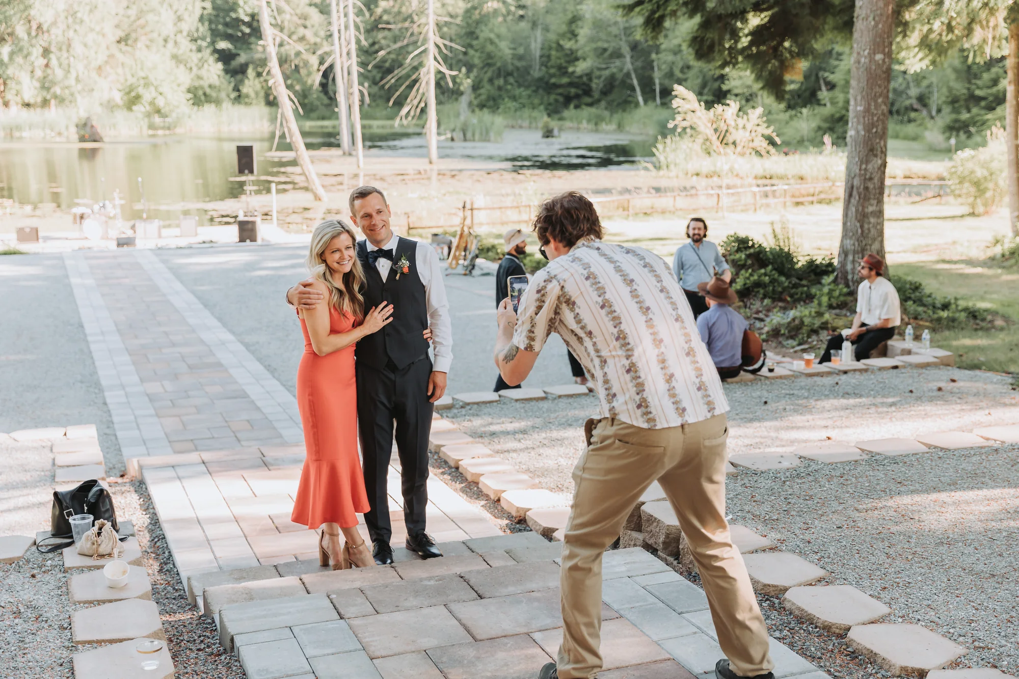 Guests posing on the paver path with the lake behind
