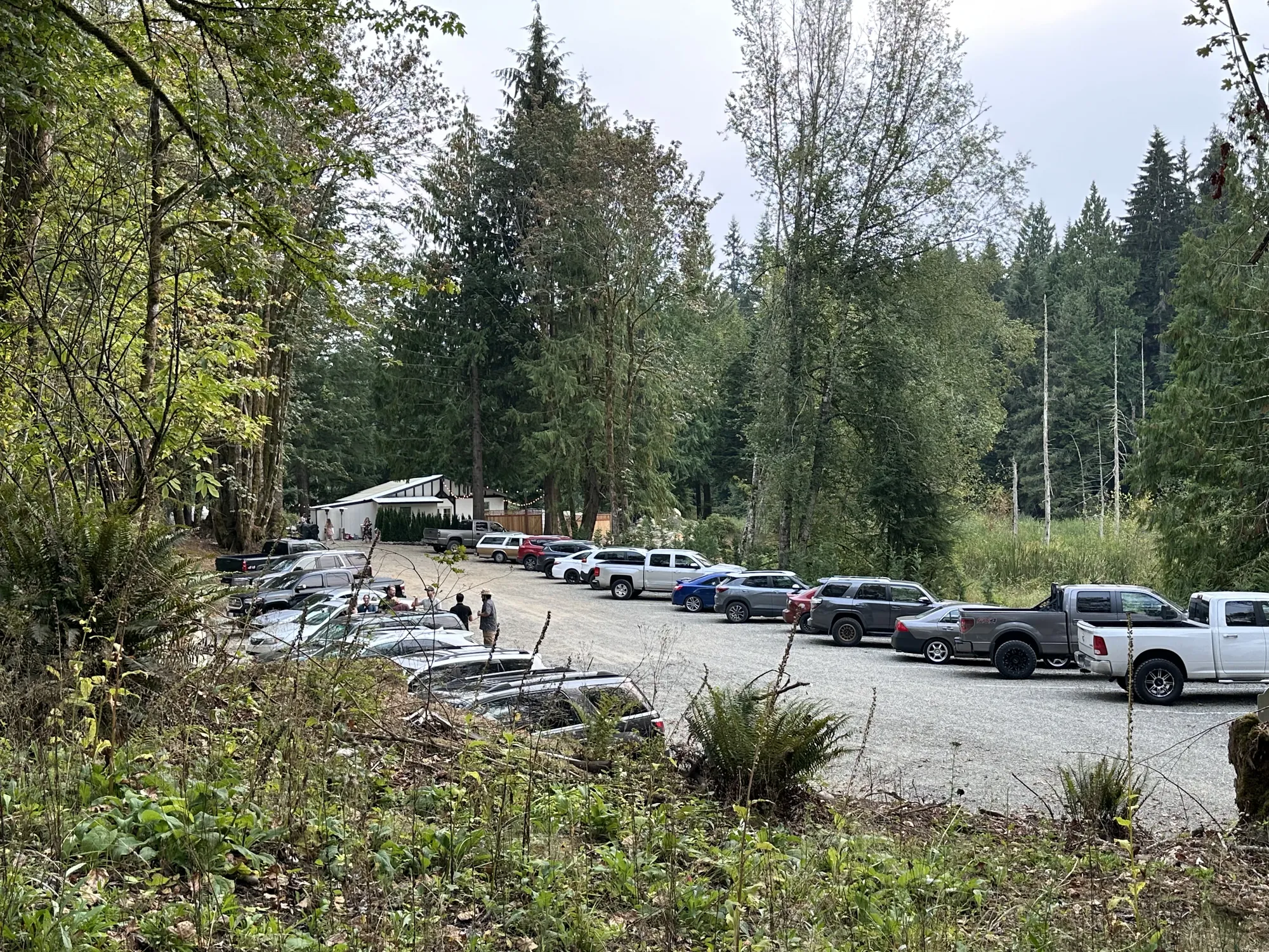 The gravel parking lot among the trees, with room for guests' cars