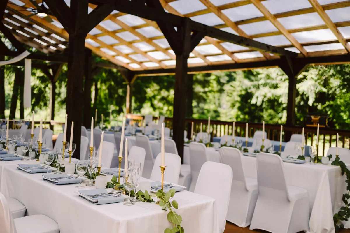 Candlelit reception tables under the covered patio